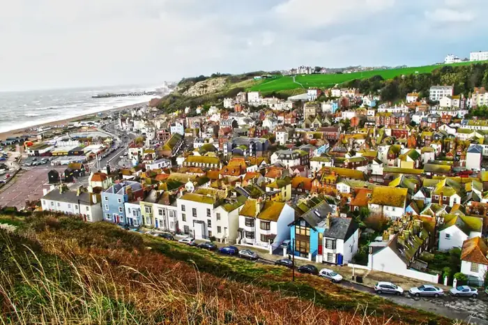 Roofs of an English seaside town rising above the shoreline