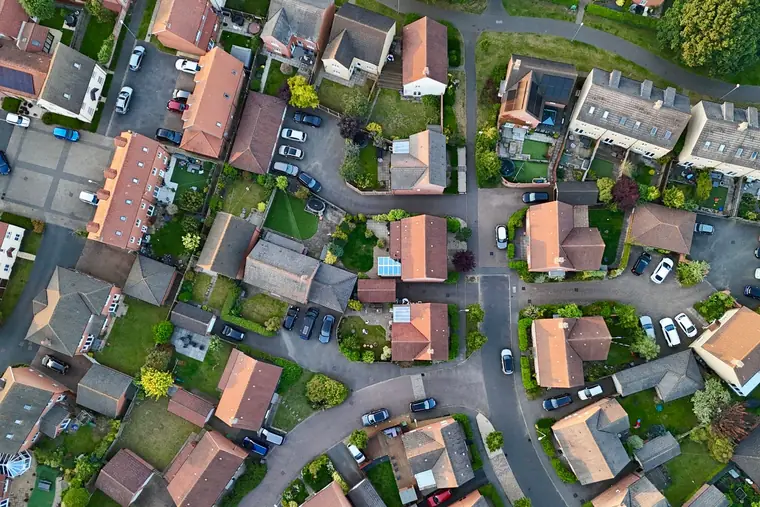 Aerial view of a British housing estate showing pitched, tiled roofs and hipped bungalow ends